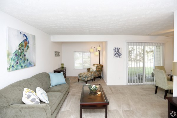Spacious living room with modern decor in The Retreat Northwest Apartments