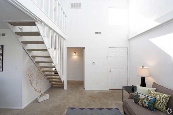 Living room featuring modern decor and bright lighting at The Retreat Northwest Apartments