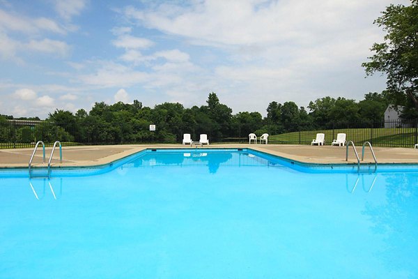 Resort-style pool with lounge chairs at The Retreat Northwest Apartments, offering relaxation and leisure