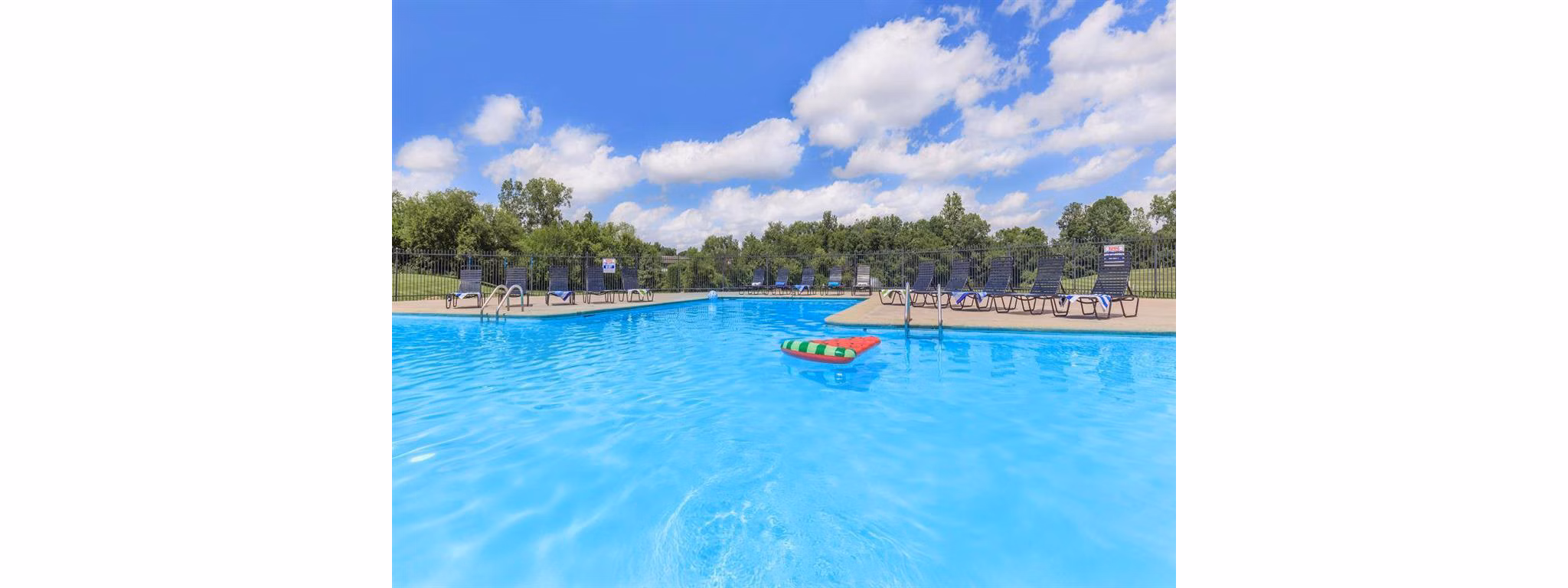 Refreshing outdoor pool at The Retreat Northwest Apartments with lush landscaping