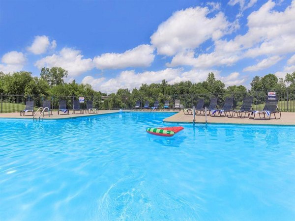 Refreshing outdoor pool at The Retreat Northwest Apartments with lush landscaping