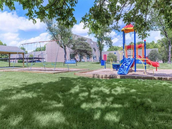 Modern playground with swings and slides at The Retreat Northwest Apartments, perfect for family-friendly outdoor recreation