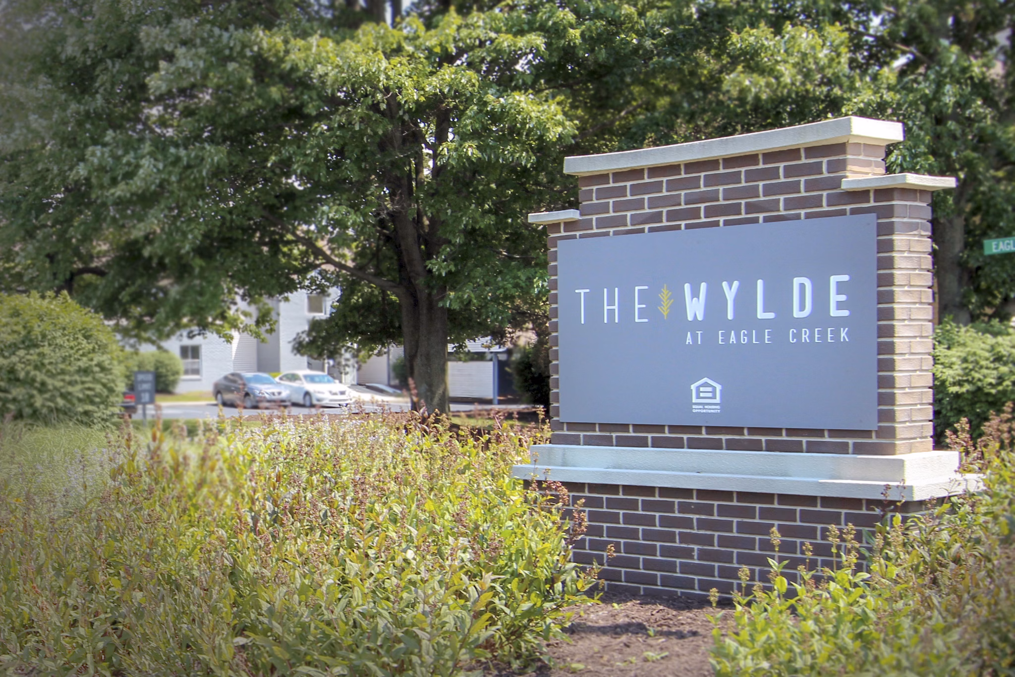 Wylde at Eagle Creek: Entrance signage at modern luxury apartments surrounded by nature trails