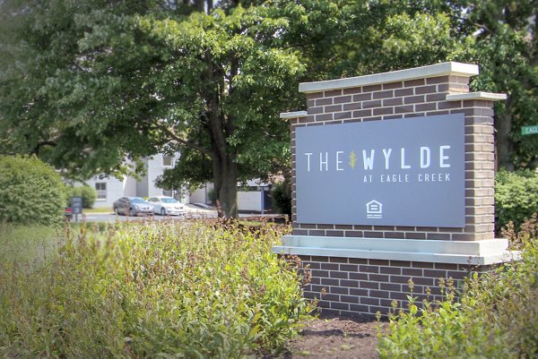 Wylde at Eagle Creek: Entrance signage at modern luxury apartments surrounded by nature trails