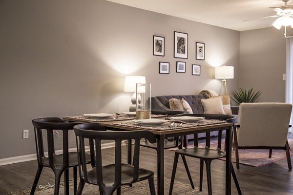 Dining area with modern decor and sleek furniture in Wylde at Eagle Creek Apartments, perfect for entertaining guests