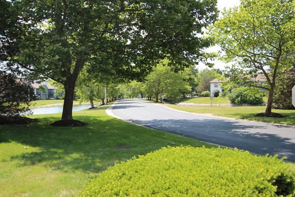 Tree-lined pathways and community park in Wylde at Eagle Creek Apartments neighborhood