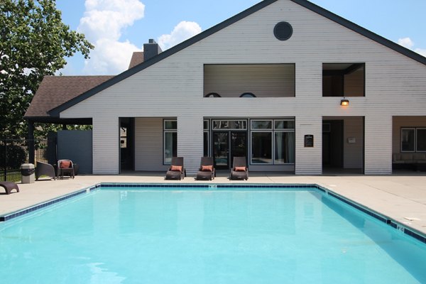 Resort-style pool with sun loungers at Wylde at Eagle Creek Apartments