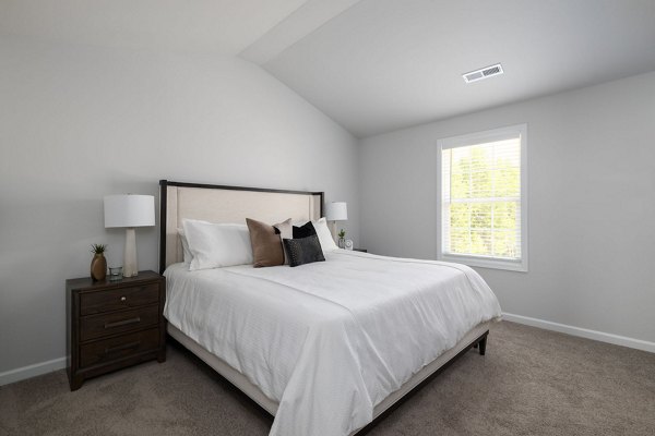 Bedroom with modern furniture and natural light at Smith Crossing Apartments