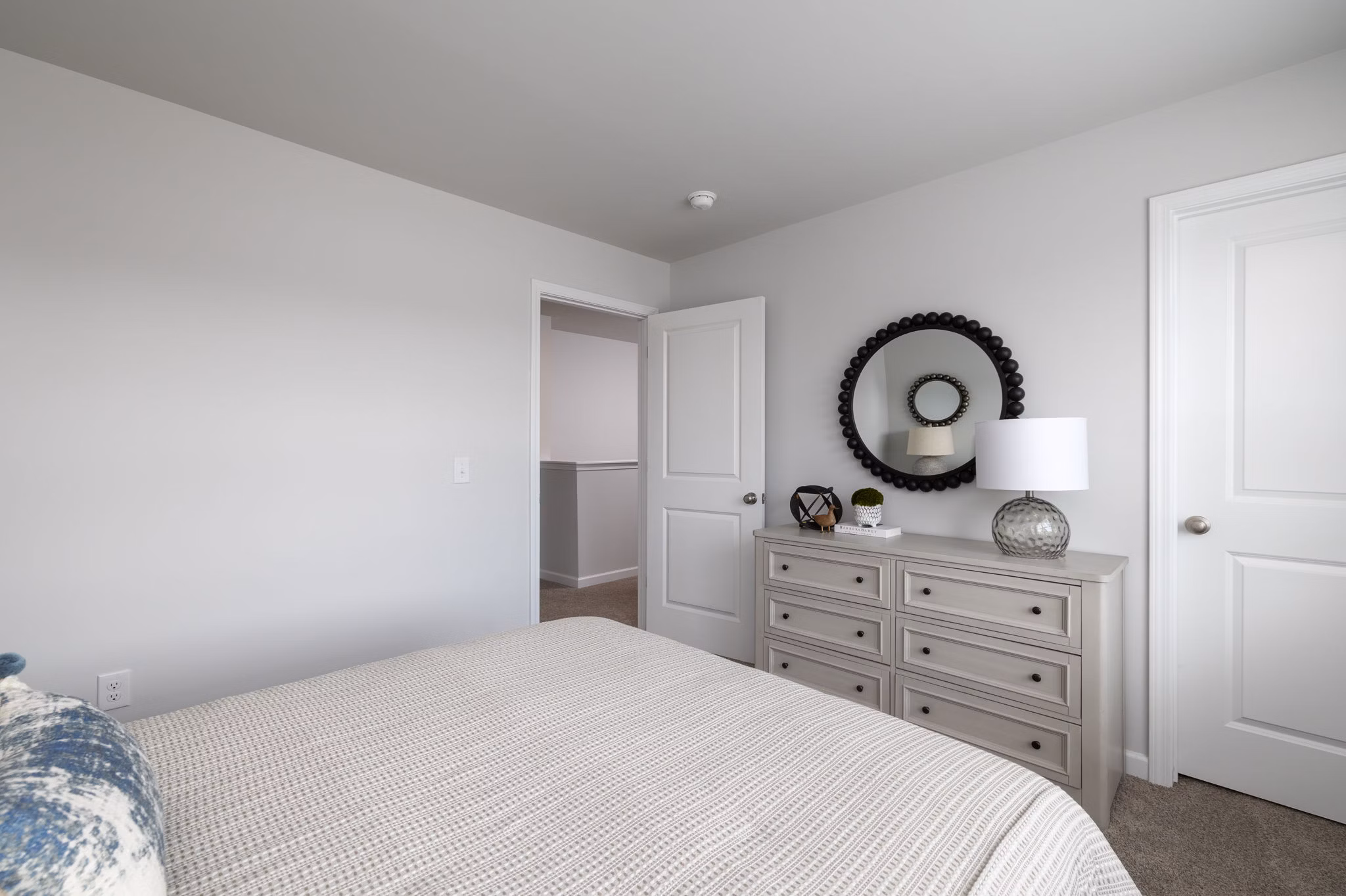 Smith Crossing Apartments: Modern bedroom with luxurious decor and ample natural light