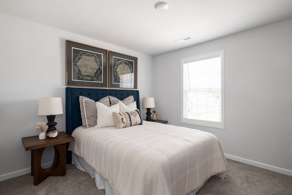 Cozy bedroom with modern furnishings in Smith Crossing Apartments