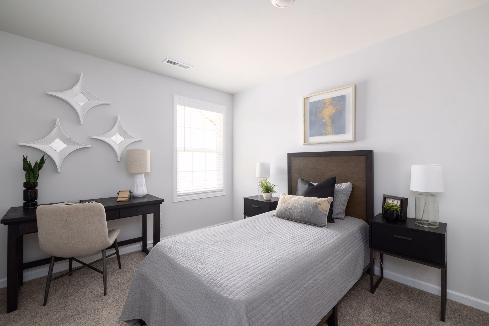 Cozy bedroom with modern decor at Smith Crossing Apartments, offering luxury living by Greystar in prime urban location