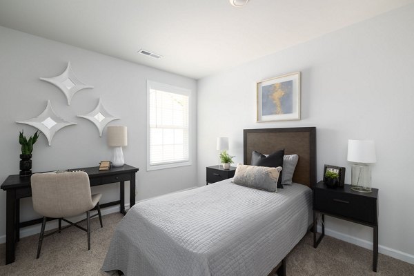 Cozy bedroom with modern decor at Smith Crossing Apartments, offering luxury living by Greystar in prime urban location