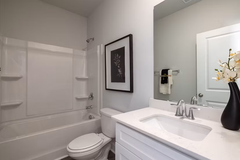Modern bathroom featuring elegant fixtures and marble accents in Smith Crossing Apartments