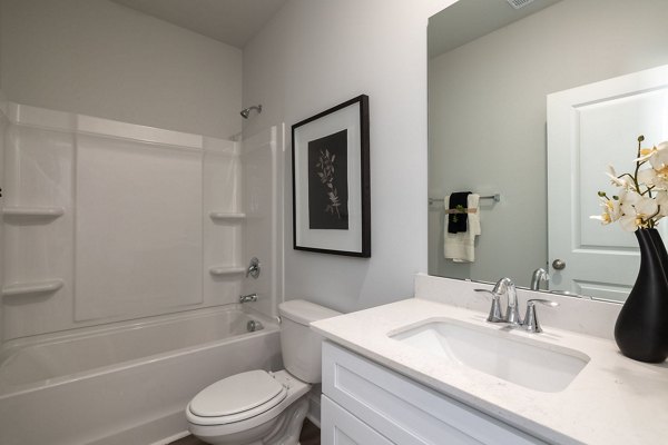Modern bathroom featuring elegant fixtures and marble accents in Smith Crossing Apartments