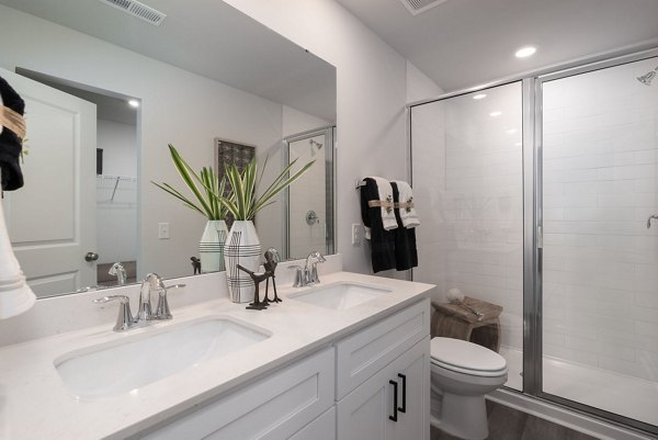 Bathroom with sleek fixtures and marble countertops at Smith Crossing Apartments