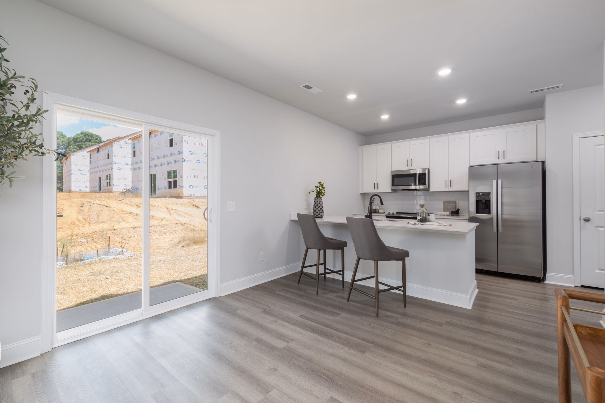 Modern kitchen with stainless steel appliances in Spire at Smith Crossing Apartments
