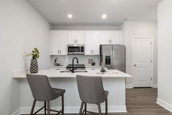 Modern kitchen with stainless steel appliances at Spire at Smith Crossing Apartments Greystar luxury living