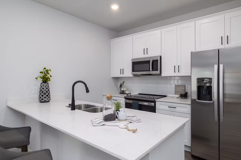 Kitchen with modern appliances and sleek countertops in Spire at Smith Crossing Apartments
