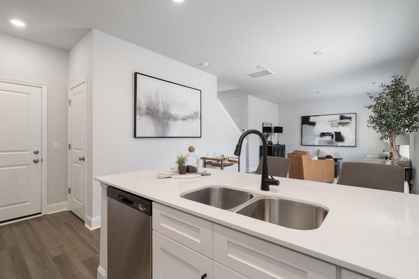 Modern kitchen with stainless steel appliances in Spire at Smith Crossing Apartments