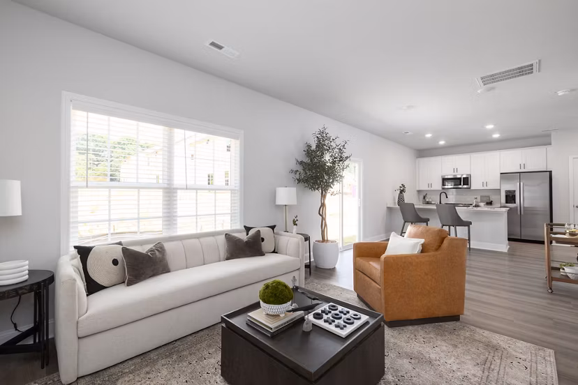 Modern living room with sleek furnishings at Spire at Smith Crossing Apartments, highlighting a stylish design and comfortable seating arrangement