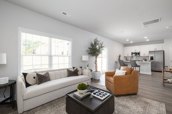 Modern living room with sleek furnishings at Spire at Smith Crossing Apartments, highlighting a stylish design and comfortable seating arrangement