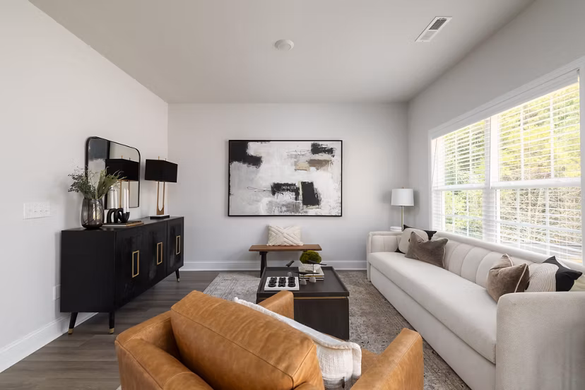 Spacious living room with modern decor at Spire at Smith Crossing Apartments, showcasing luxury living in a prime location