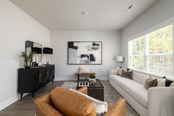 Spacious living room with modern decor at Spire at Smith Crossing Apartments, showcasing luxury living in a prime location