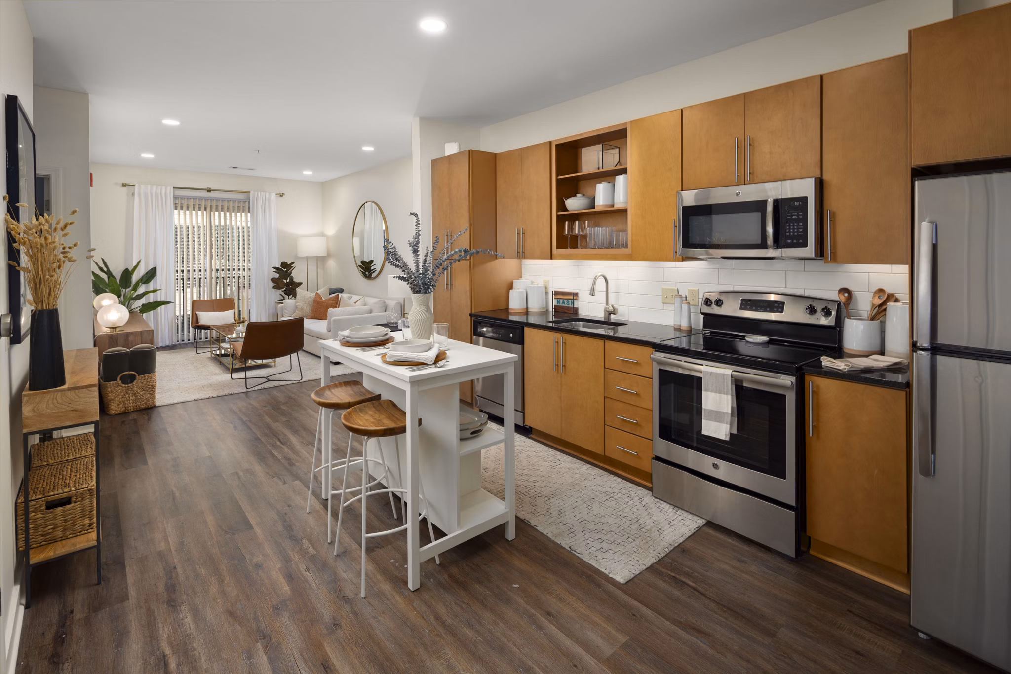 Modern kitchen with stainless steel appliances in Station 40 Apartments