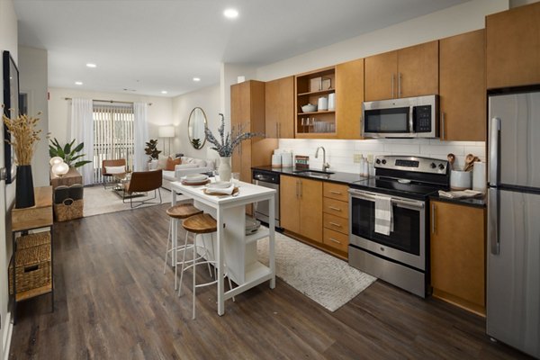 Modern kitchen with stainless steel appliances in Station 40 Apartments