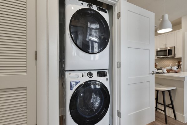 Laundry room featuring modern appliances at Lenox Grandview Apartments