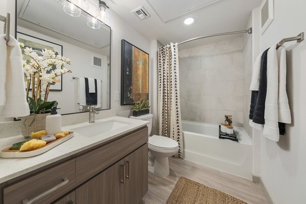 Contemporary bathroom featuring sleek fixtures and ample lighting at Vero Tempe Apartments