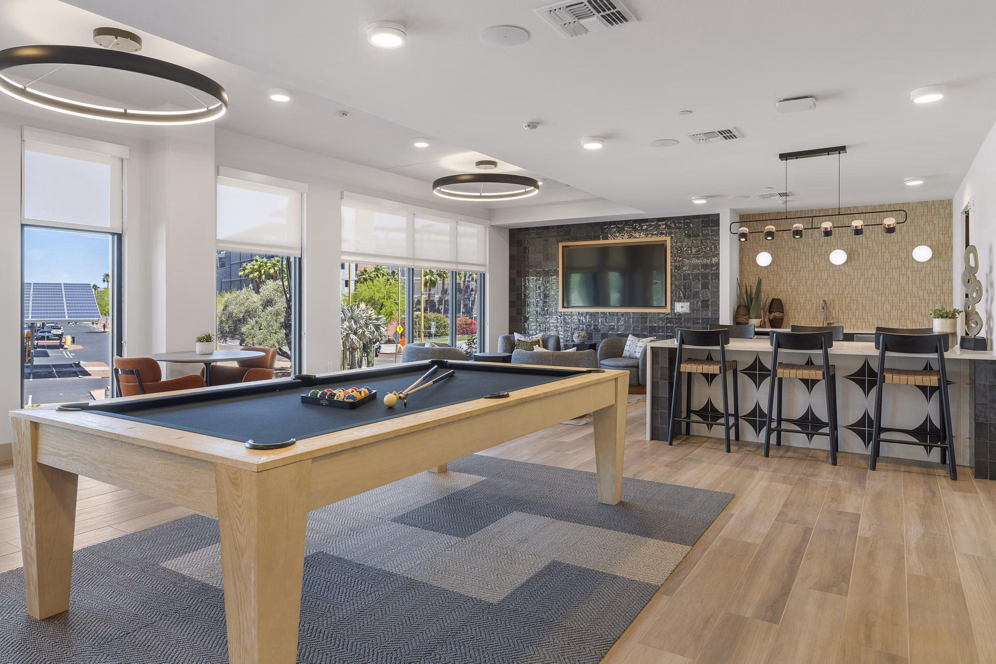 Vero Tempe Apartments: Modern clubhouse featuring stylish seating areas and billiards table in luxury apartment community