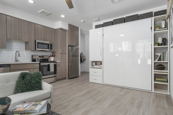 Bright kitchen with modern appliances and granite countertops in Vero Tempe Apartments