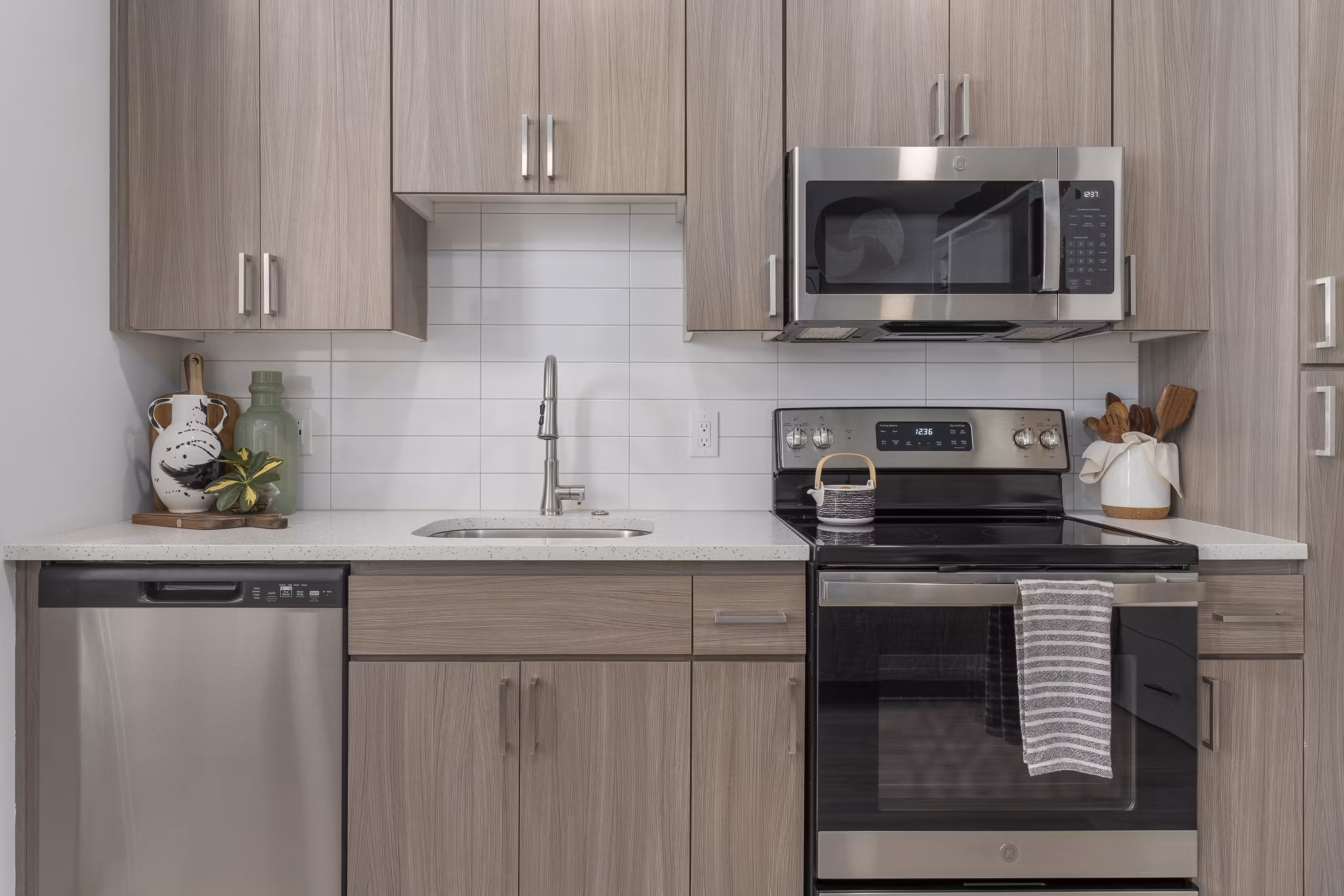 Modern kitchen with stainless steel appliances and sleek cabinetry at Vero Tempe Apartments