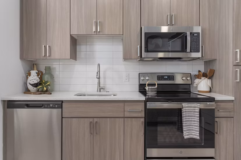 Modern kitchen with stainless steel appliances and sleek cabinetry at Vero Tempe Apartments