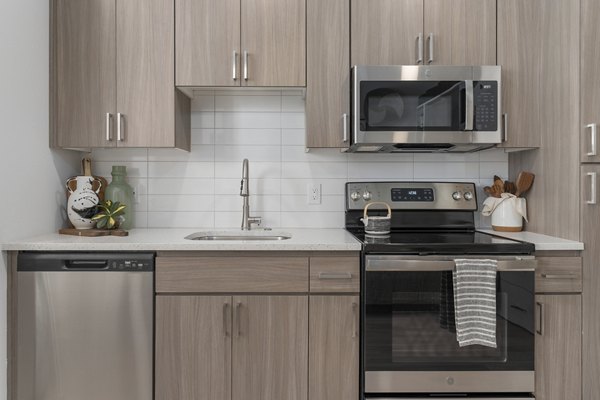 Modern kitchen with stainless steel appliances and sleek cabinetry at Vero Tempe Apartments