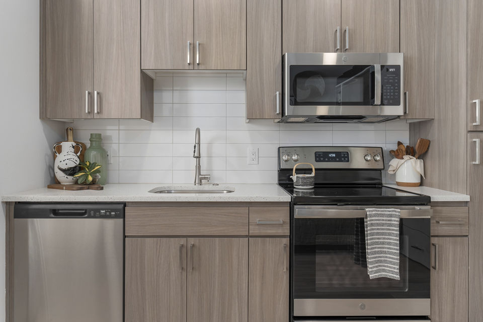 Modern kitchen with stainless steel appliances and sleek cabinetry at Vero Tempe Apartments