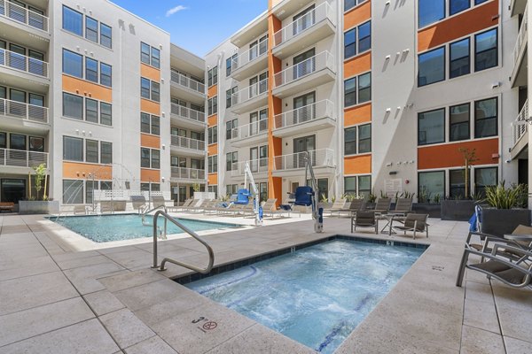 Resort-style pool with lounge chairs at Vero Tempe Apartments, offering luxury living in a vibrant community setting