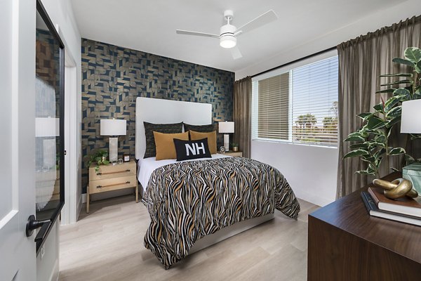 Cozy bedroom with elegant decor at Marlowe Centennial Hills Apartments featuring plush bedding and warm lighting