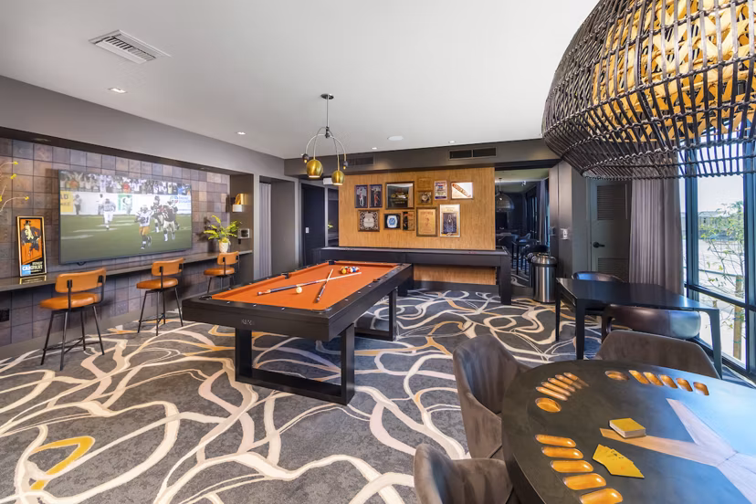 Modern game room with pool table and lounge seating at Marlowe Centennial Hills Apartments