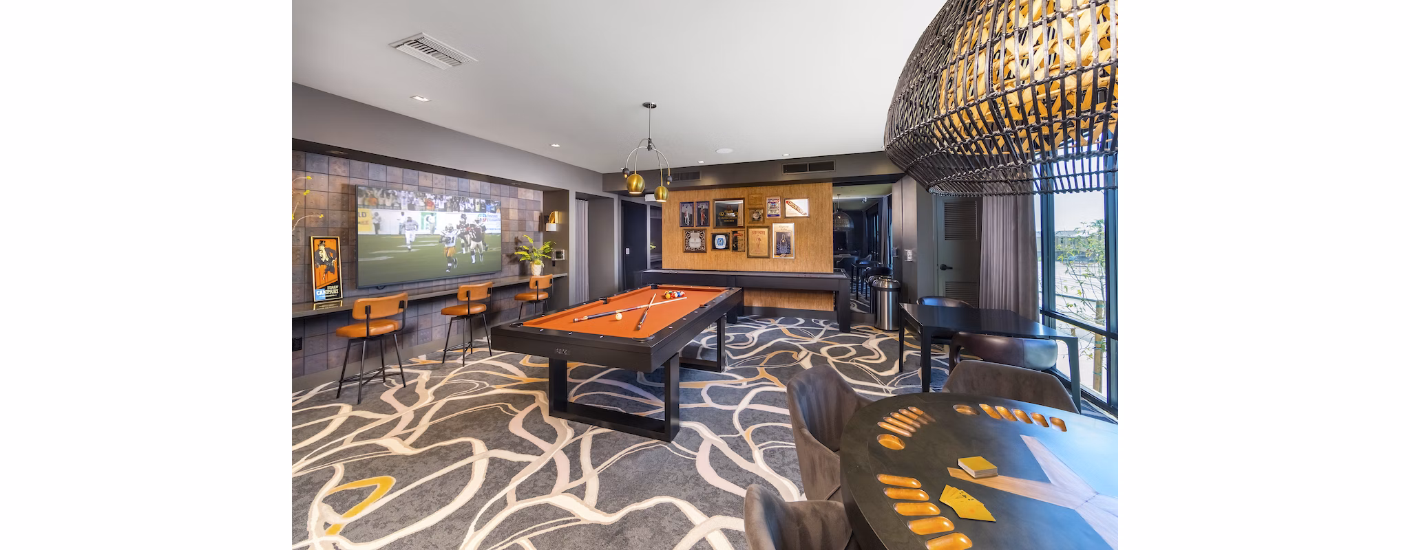 Modern game room with pool table and lounge seating at Marlowe Centennial Hills Apartments
