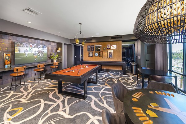 Modern game room with pool table and lounge seating at Marlowe Centennial Hills Apartments
