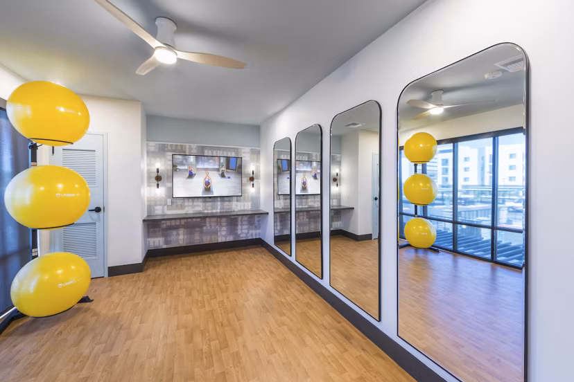 Spacious yoga-spin studio with mirrored walls at Marlowe Centennial Hills Apartments, ideal for fitness enthusiasts seeking luxury amenities