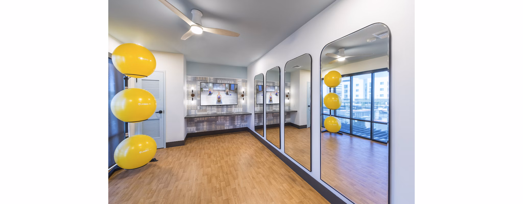 Spacious yoga-spin studio with mirrored walls at Marlowe Centennial Hills Apartments, ideal for fitness enthusiasts seeking luxury amenities