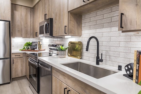 Open-concept kitchen with stainless steel appliances at Marlowe Centennial Hills Apartments Perfect for modern luxury living