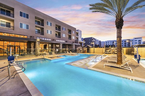 Resort-style pool with lounge area at Marlowe Centennial Hills Apartments, offering luxury living in serene surroundings