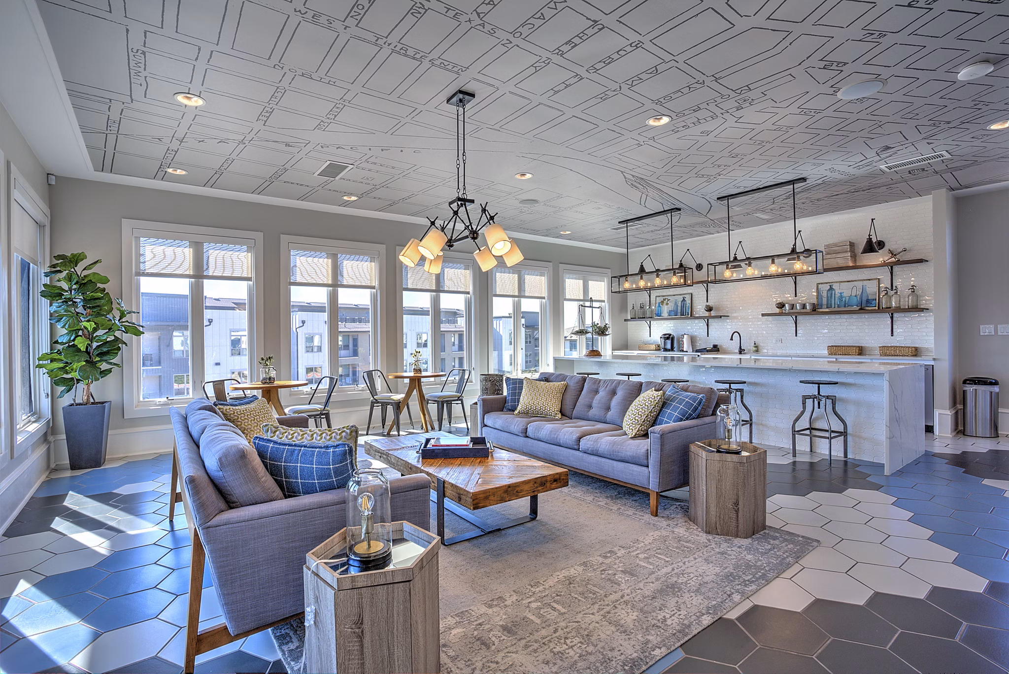 Clubhouse with modern lounge seating at The Kelley at Samuels Avenue Apartments, offering residents a luxurious social space for relaxation and gatherings