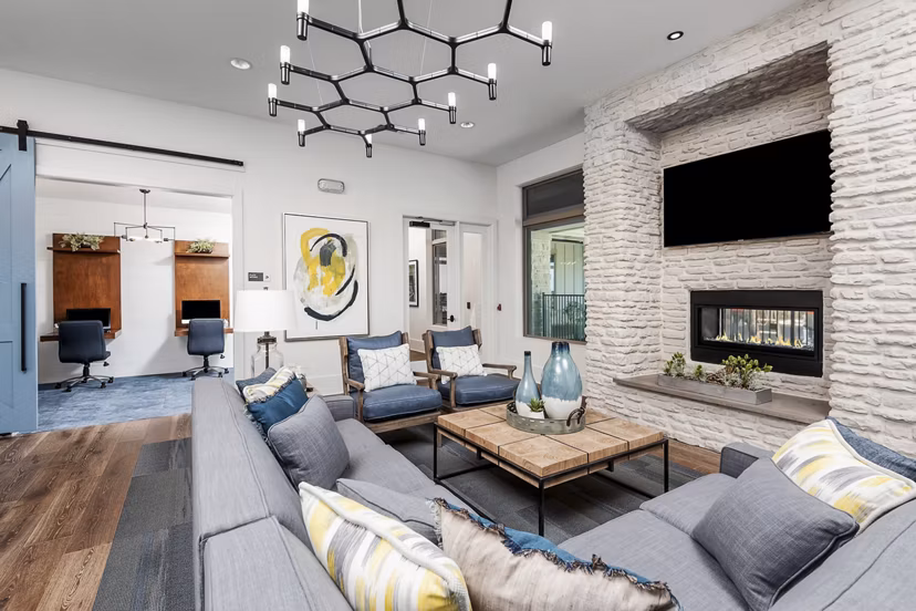 Clubhouse featuring modern design and communal seating at The Kelley at Samuels Avenue Apartments