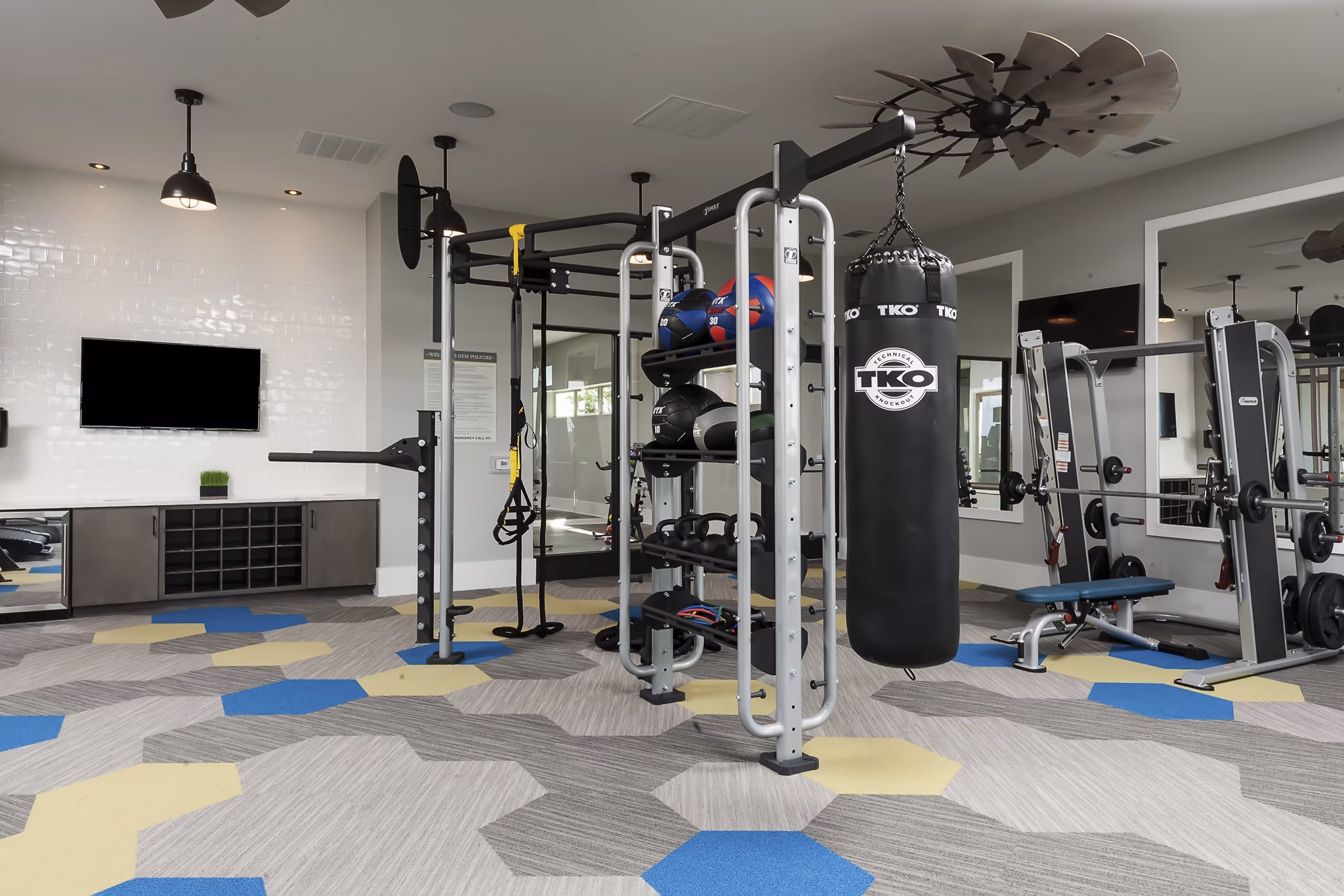 Fitness center featuring modern equipment at The Kelley at Samuels Avenue Apartments