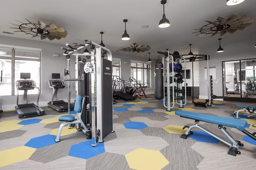 State-of-the-art fitness center with equipment at The Kelley at Samuels Avenue Apartments